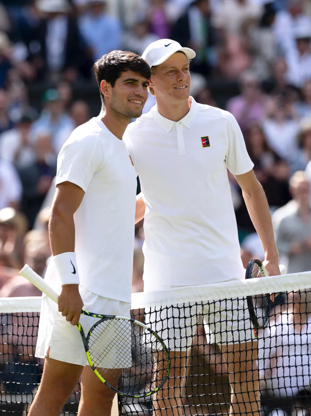 Tennisprofis Carlos Alcaraz und Janniker Sinner am Tennisnetz